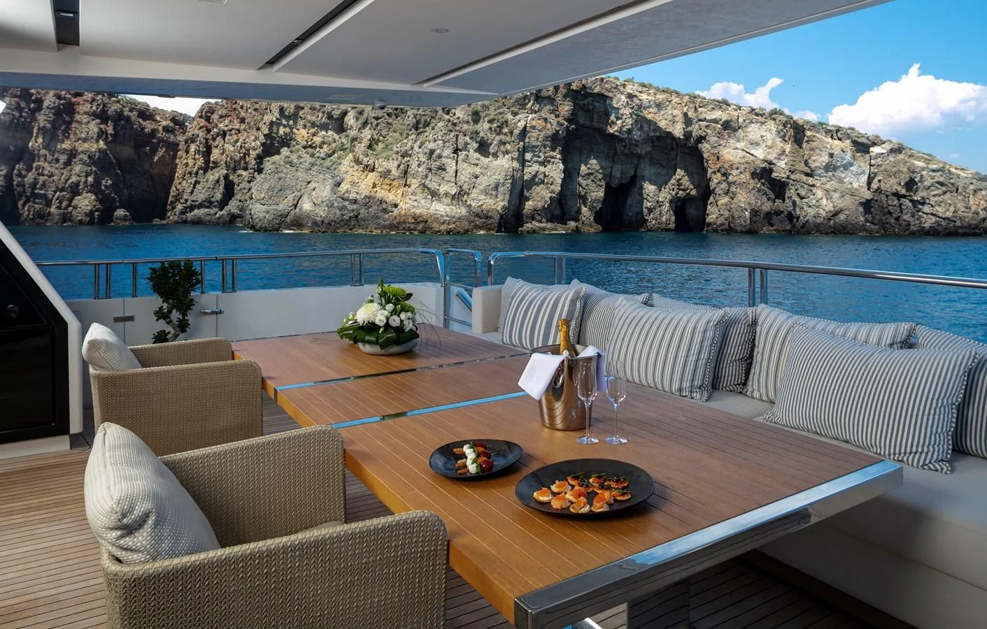 a table with a plate of food on it aboard DINAIA Yacht for Charter
