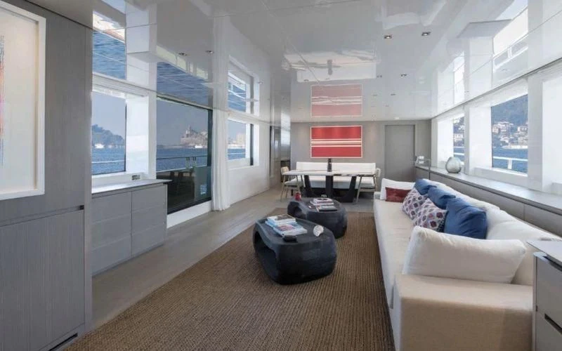 a living room with a large window aboard DINAIA Yacht for Charter