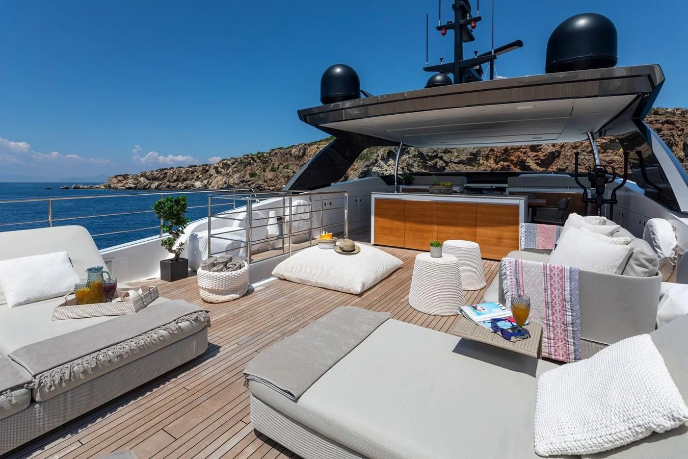 a large lounge area with a large grill and lounge chairs aboard DINAIA Yacht for Charter