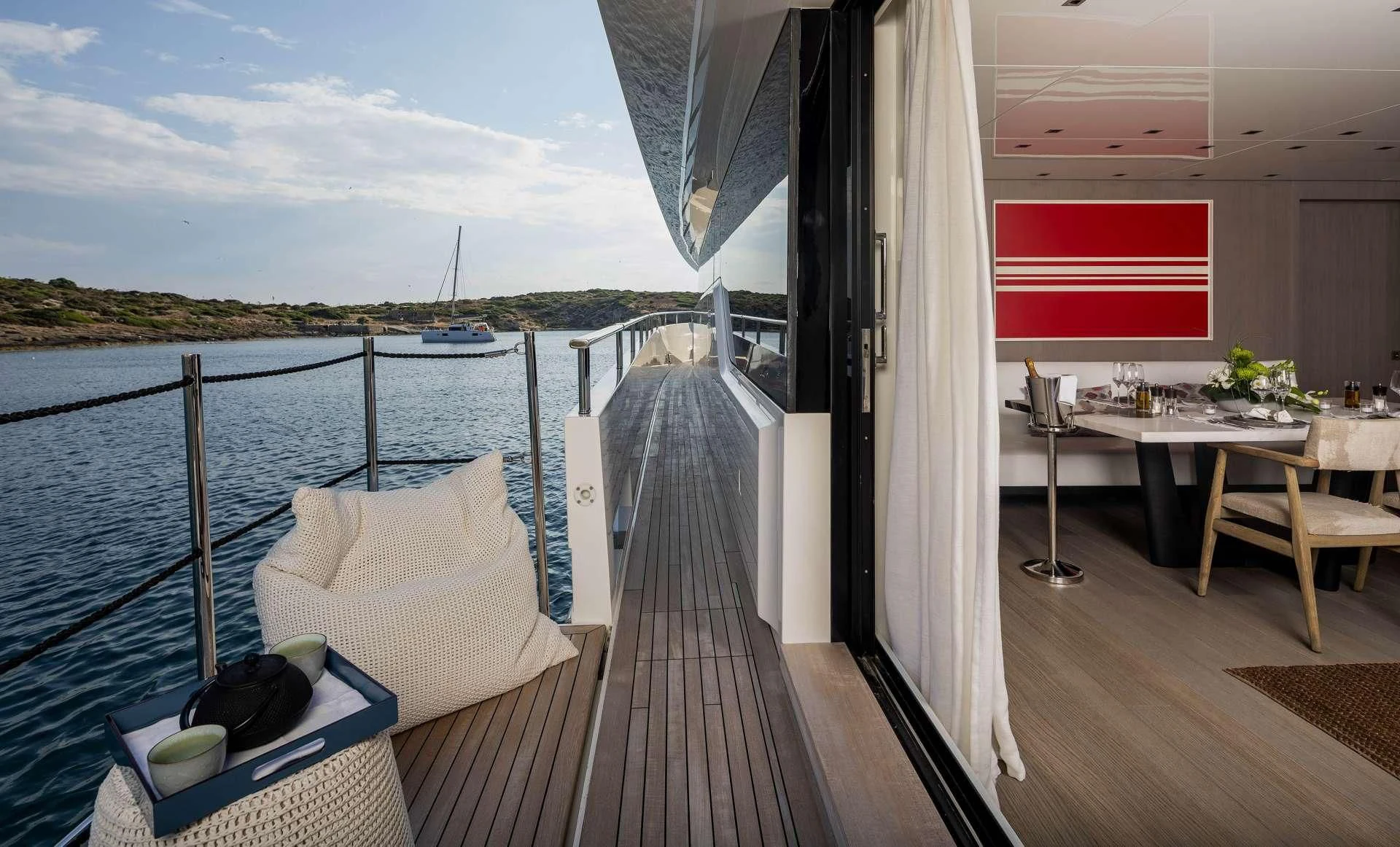 a deck with a view of a boat and a large body of water aboard DINAIA Yacht for Charter