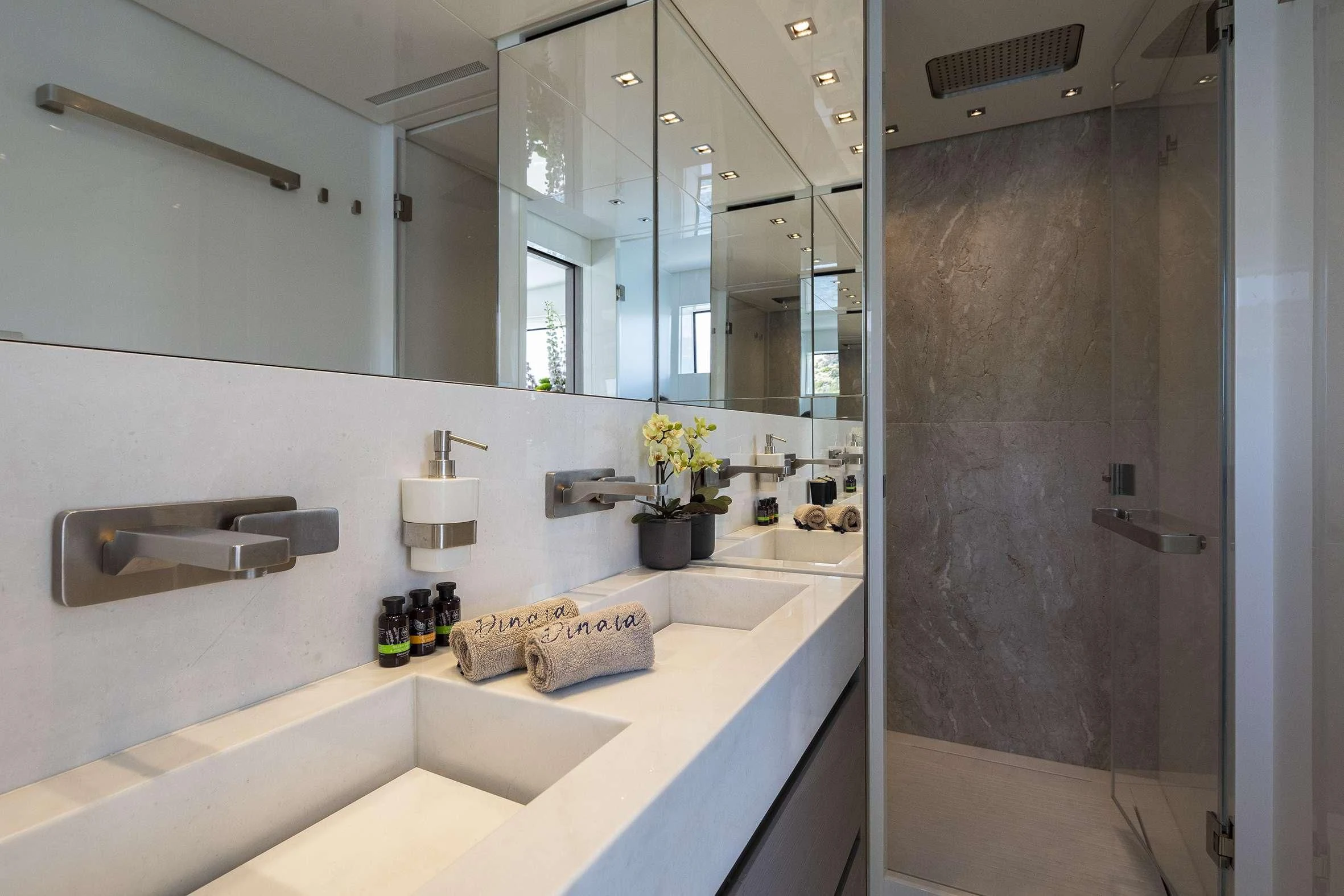 a bathroom with a large mirror aboard DINAIA Yacht for Charter