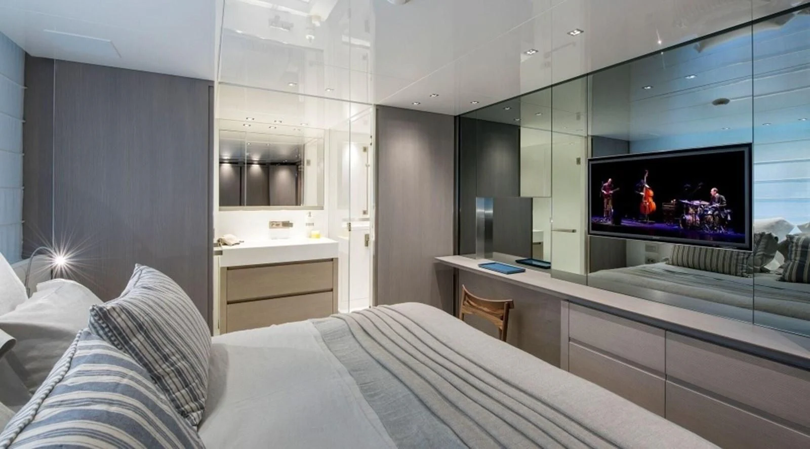 a bed and a television in a room aboard DINAIA Yacht for Charter