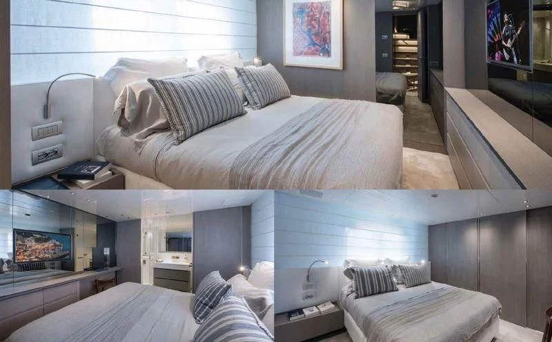 a room with a bed and a television aboard DINAIA Yacht for Charter