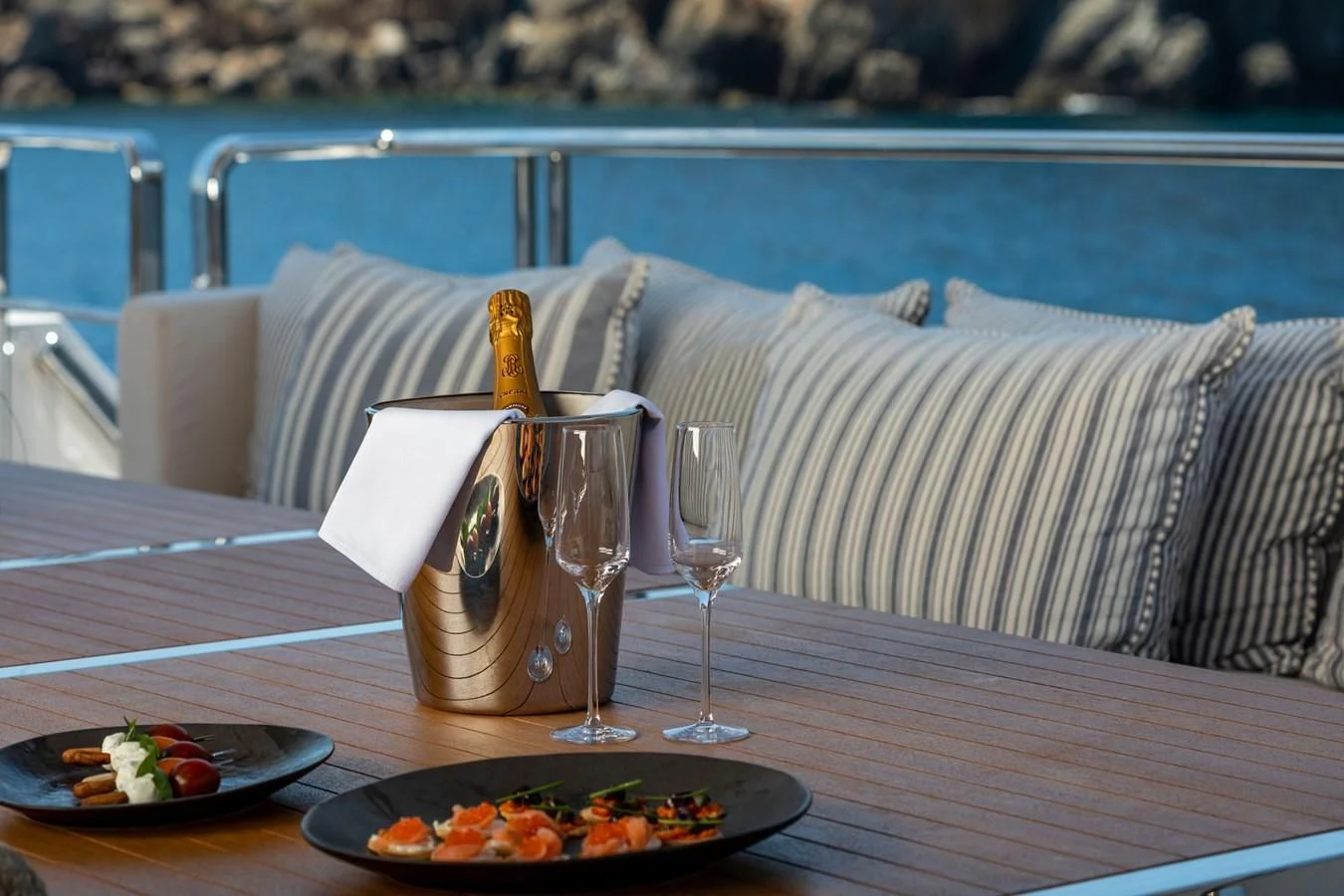 a table with food and drinks on it aboard DINAIA Yacht for Charter