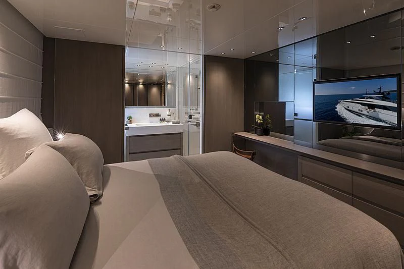 a room with a bed and a tv aboard DINAIA Yacht for Charter