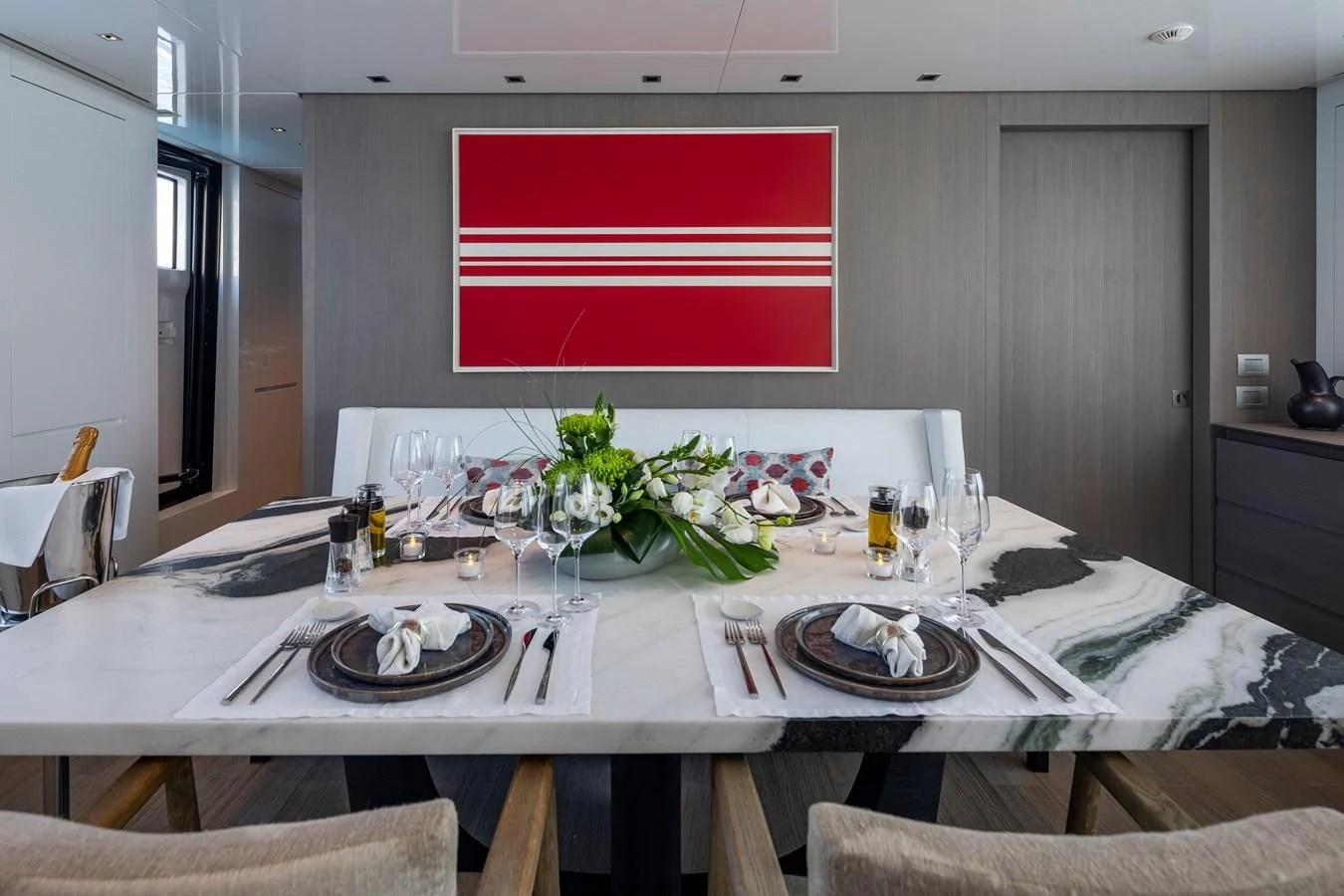 a table with plates and glasses aboard DINAIA Yacht for Charter