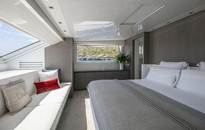 a room with a bed and a couch aboard DINAIA Yacht for Charter