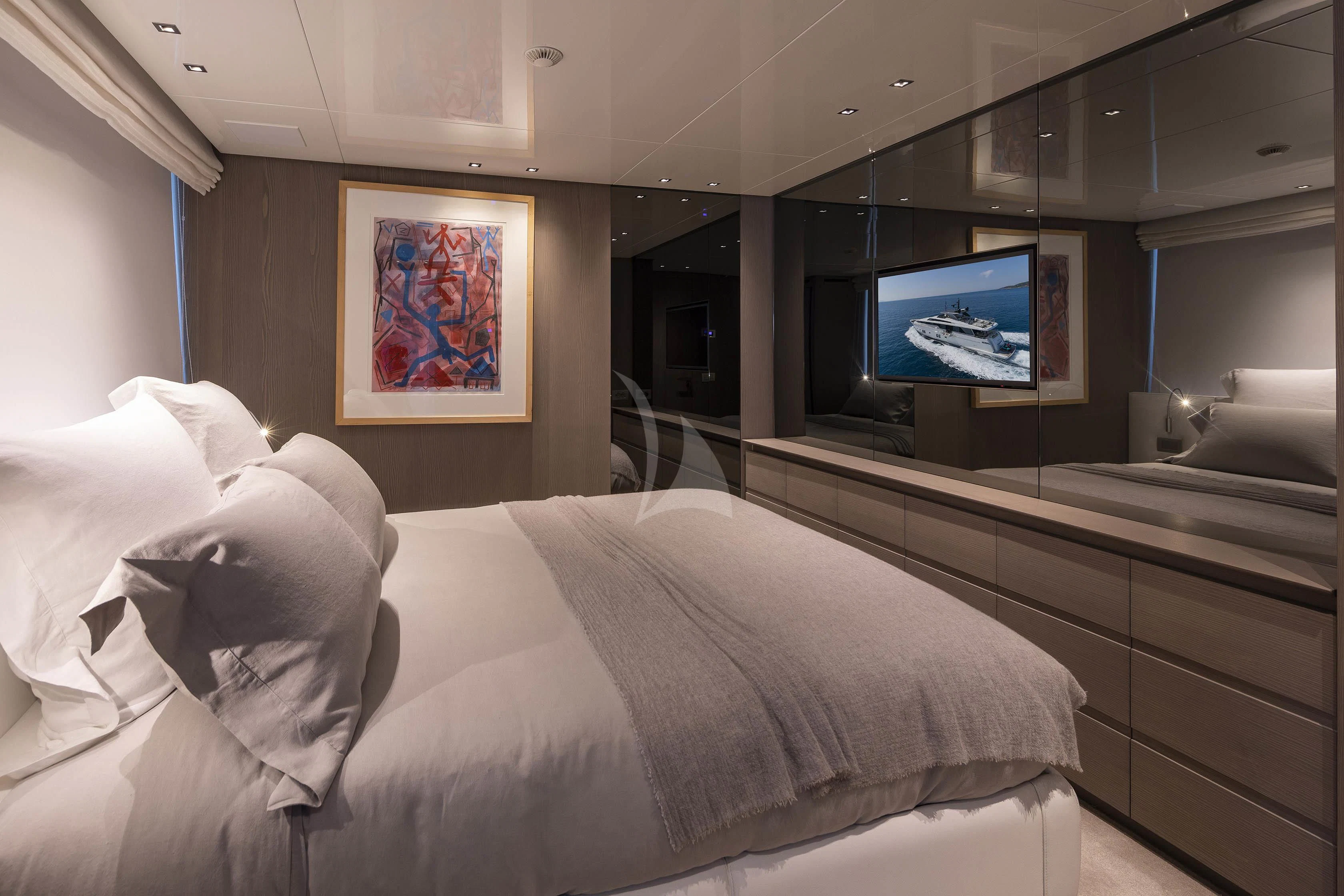 a room with a bed and a tv on the wall aboard DINAIA Yacht for Charter