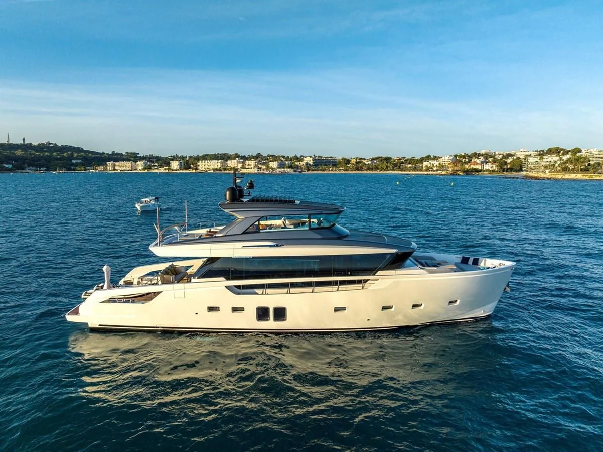 a white yacht on the water aboard LOLA Yacht for Sale