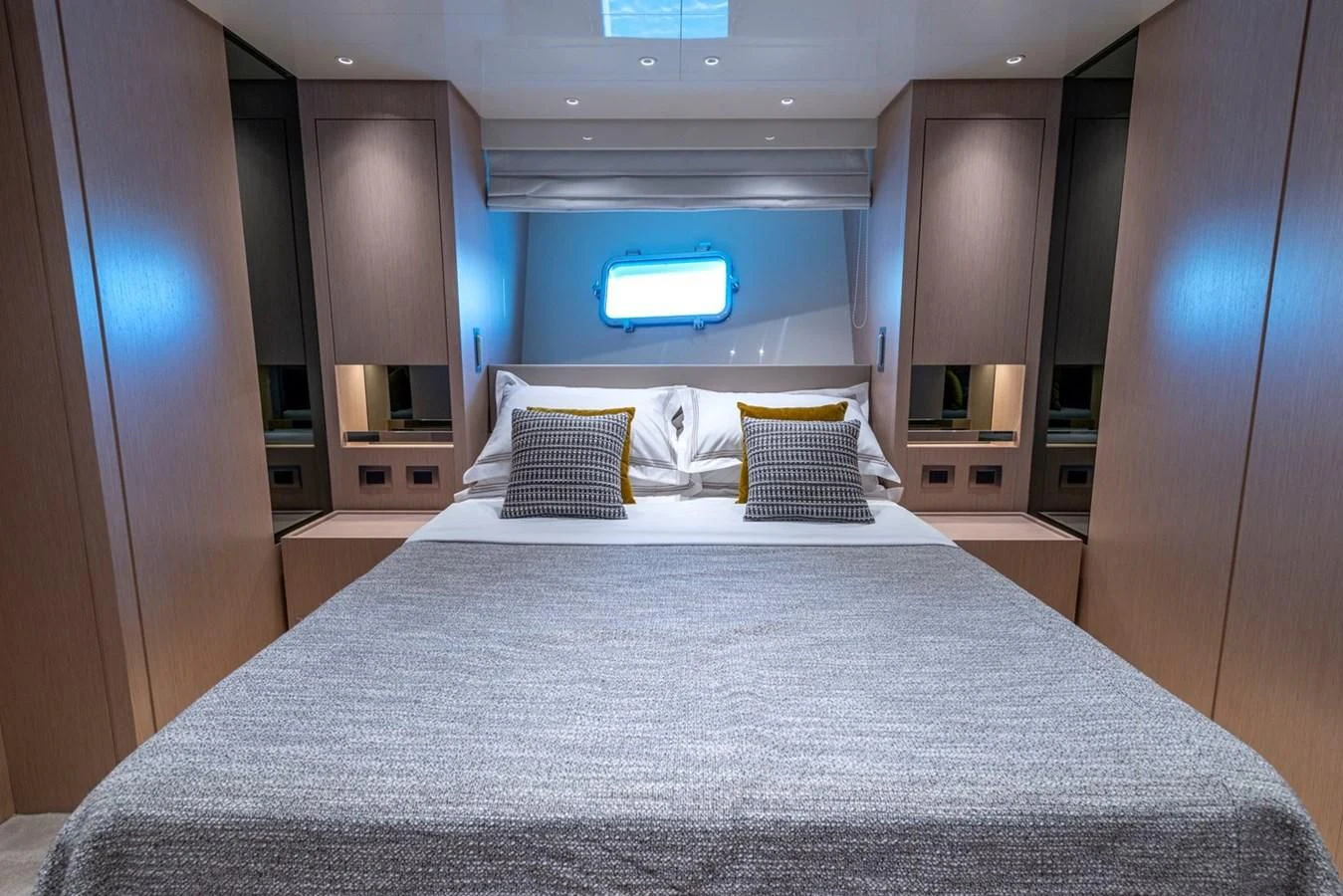 a large bed with pillows aboard LOLA Yacht for Sale