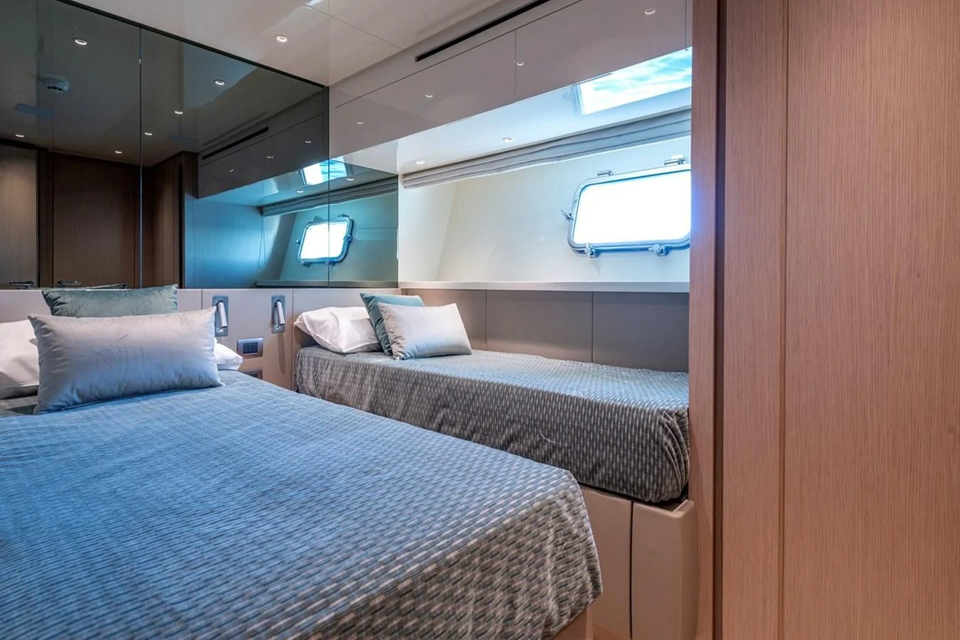 a couple of beds in a room aboard LOLA Yacht for Sale