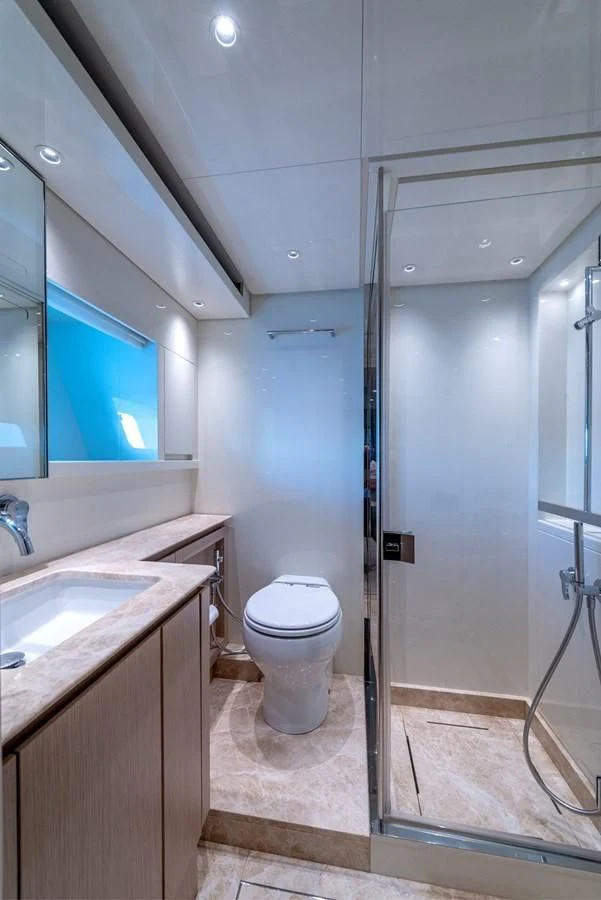 a bathroom with a sink and a toilet aboard LOLA Yacht for Sale