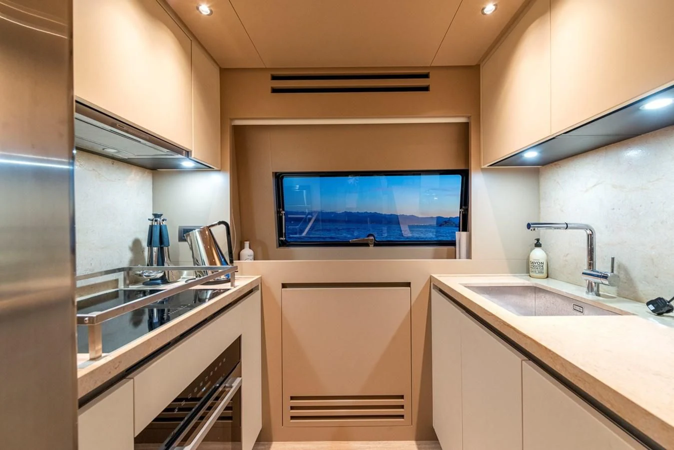 a kitchen with a large screen aboard LOLA Yacht for Sale