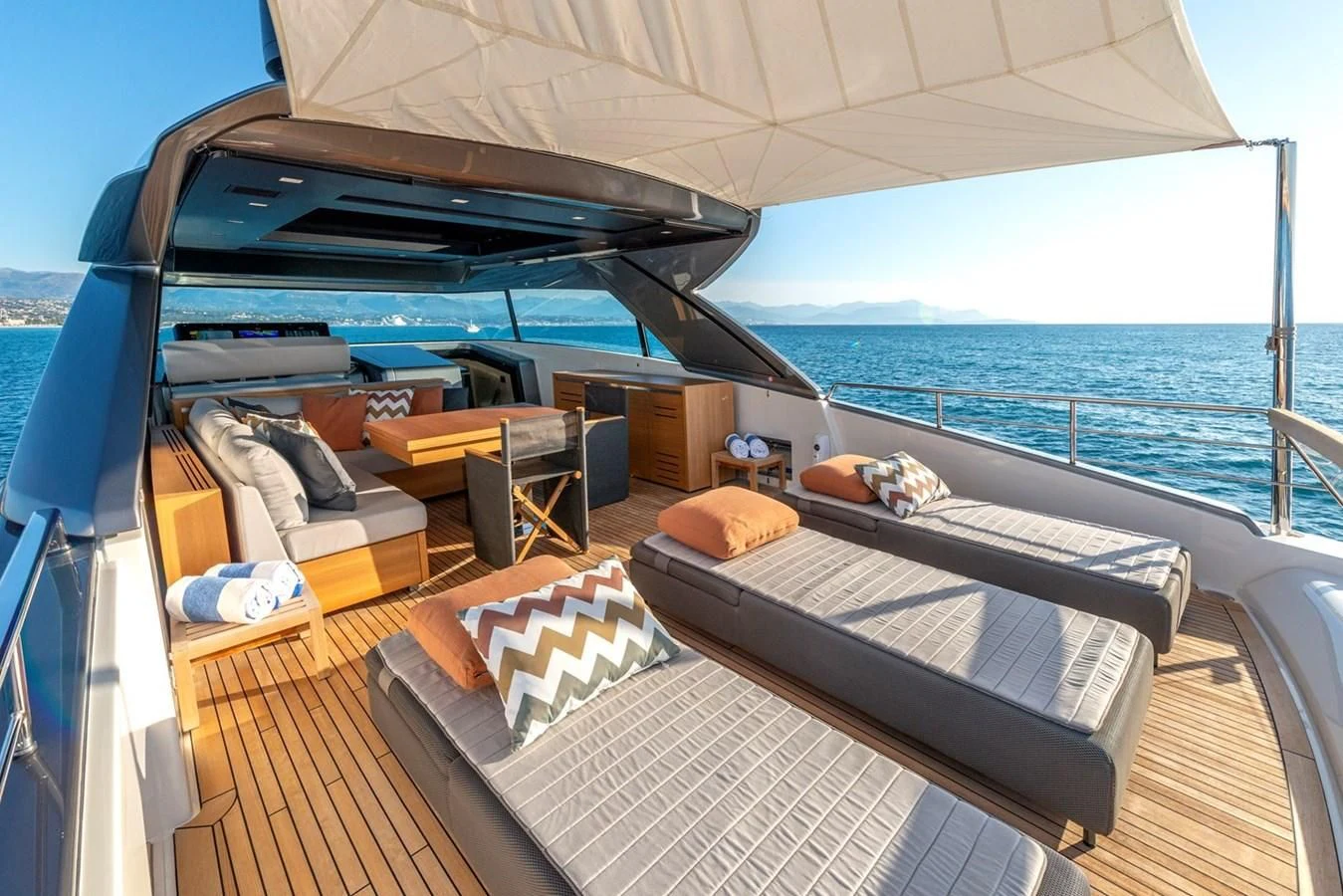 a boat with a bed and a chair on the deck aboard LOLA Yacht for Sale