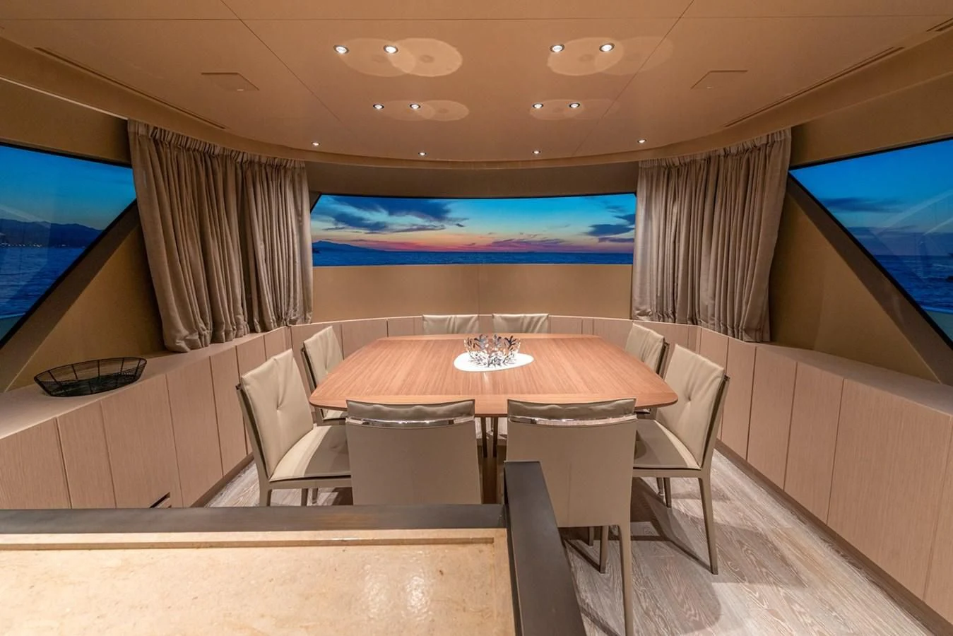 a room with a table and chairs aboard LOLA Yacht for Sale