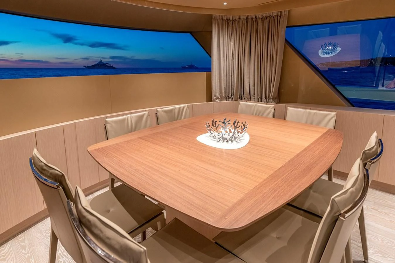 a dining table with a plate of food on it aboard LOLA Yacht for Sale