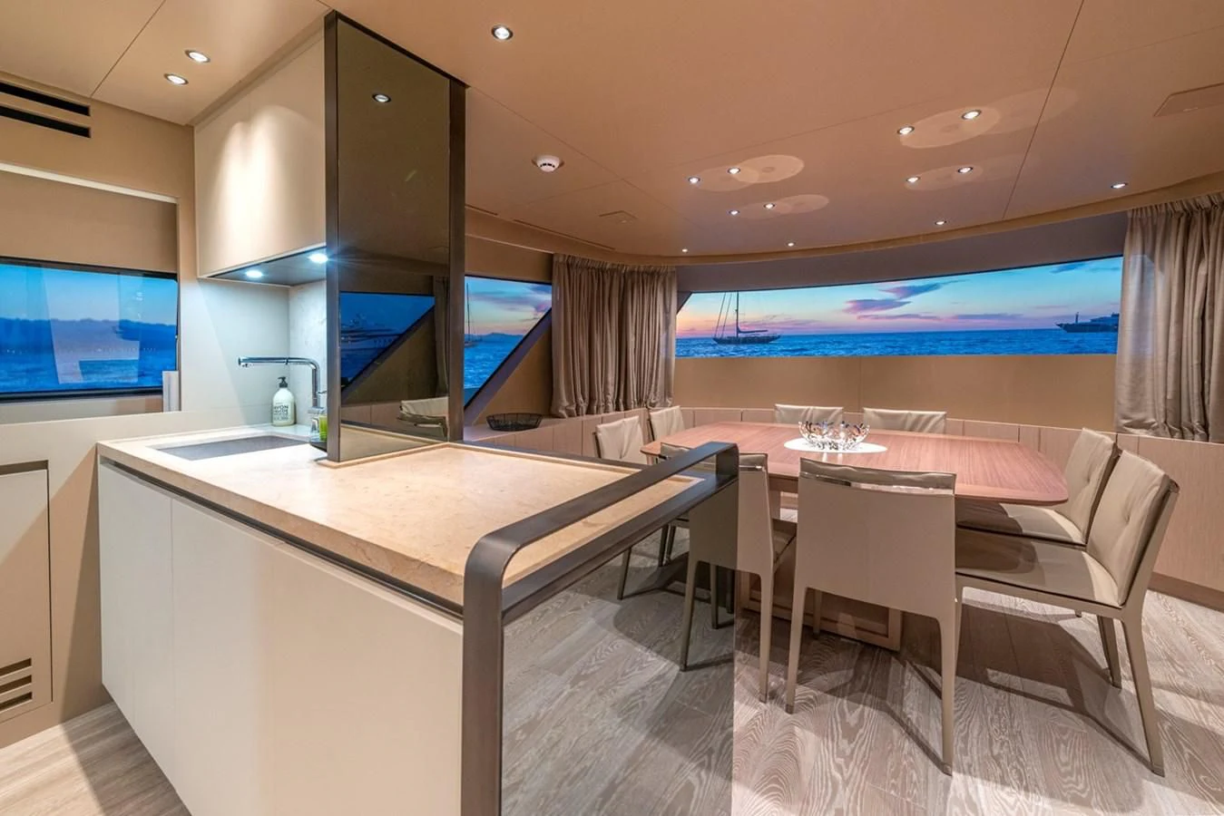 a room with a table and chairs aboard LOLA Yacht for Sale