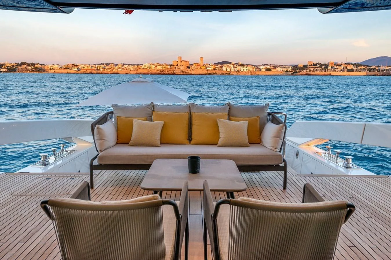 a couch and chairs on a table on a boat aboard LOLA Yacht for Sale