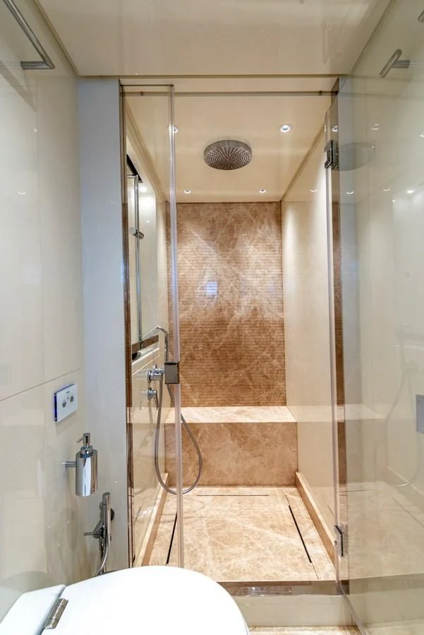 a bathroom with a shower aboard LOLA Yacht for Sale