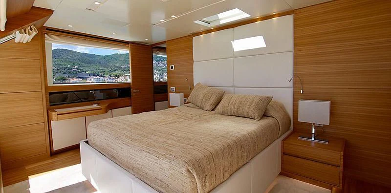a room with a bed and a desk aboard CHRISTINA Yacht for Sale