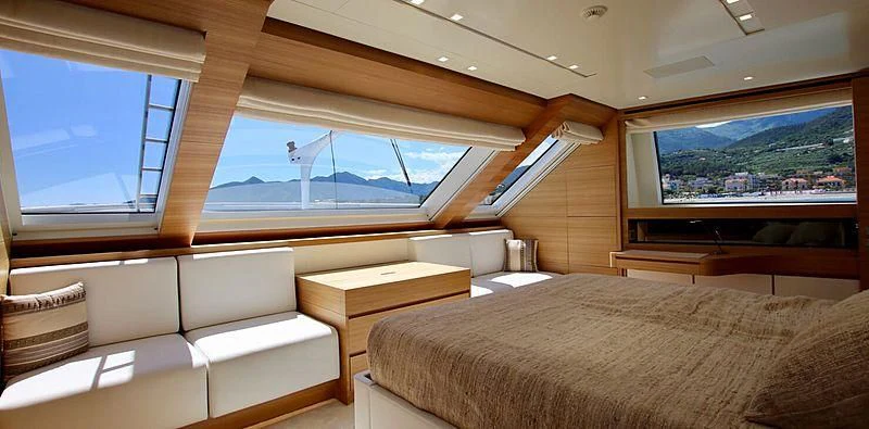 a room with a bed and a tv on the wall aboard CHRISTINA Yacht for Sale
