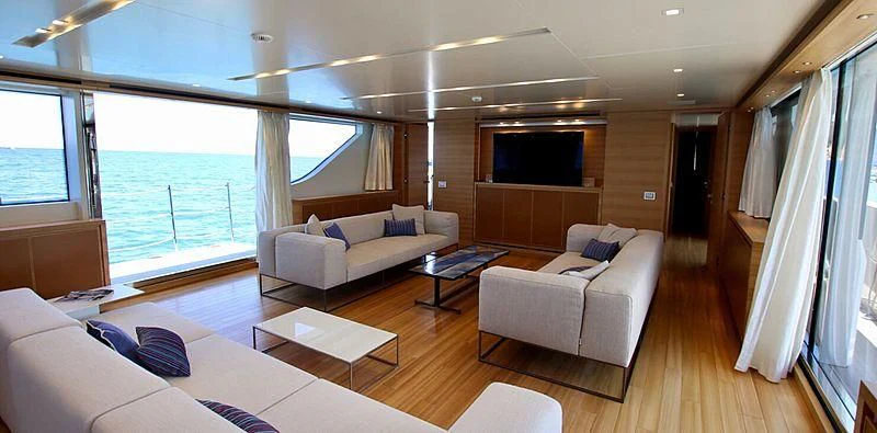 a living room with a large window aboard CHRISTINA Yacht for Sale