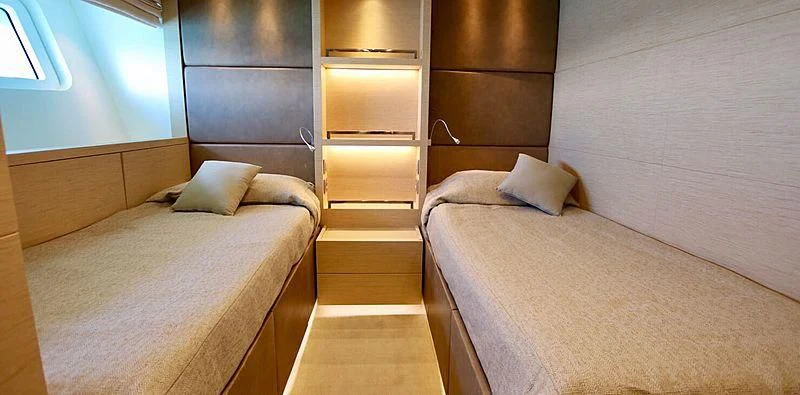 a room with a bed and a dresser aboard CHRISTINA Yacht for Sale