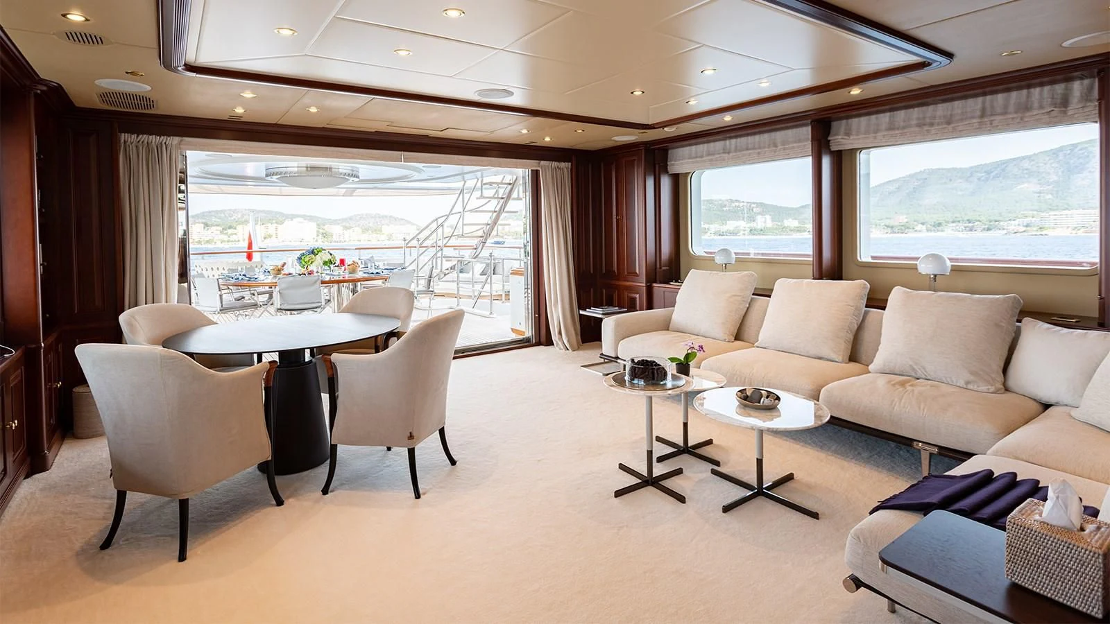 a room with a couch and a table and a window aboard INCAL Yacht for Sale