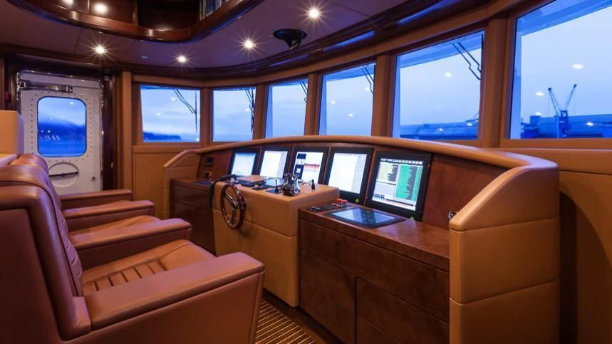 a room with a couch and a desk with a computer on it aboard INCAL Yacht for Sale
