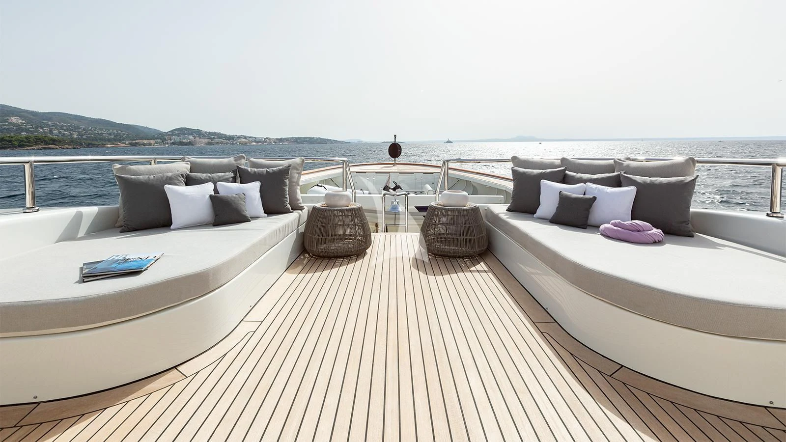 a room with a bed and a table on the deck aboard INCAL Yacht for Sale