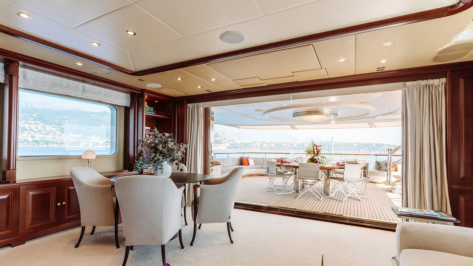 a room with tables and chairs aboard INCAL Yacht for Sale