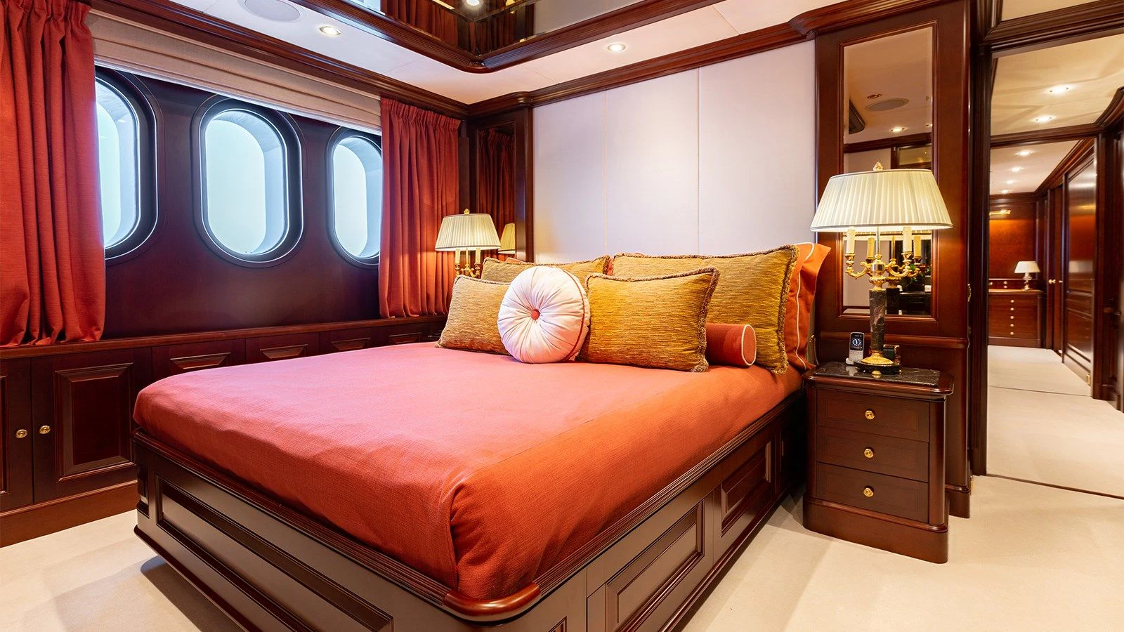 a bed with a red blanket aboard INCAL Yacht for Sale