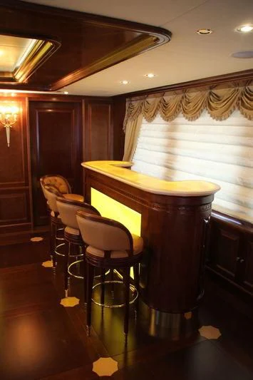 a table and chairs in a room aboard INCAL Yacht for Sale