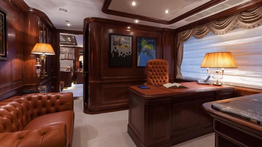 a room with a desk and a couch aboard INCAL Yacht for Sale