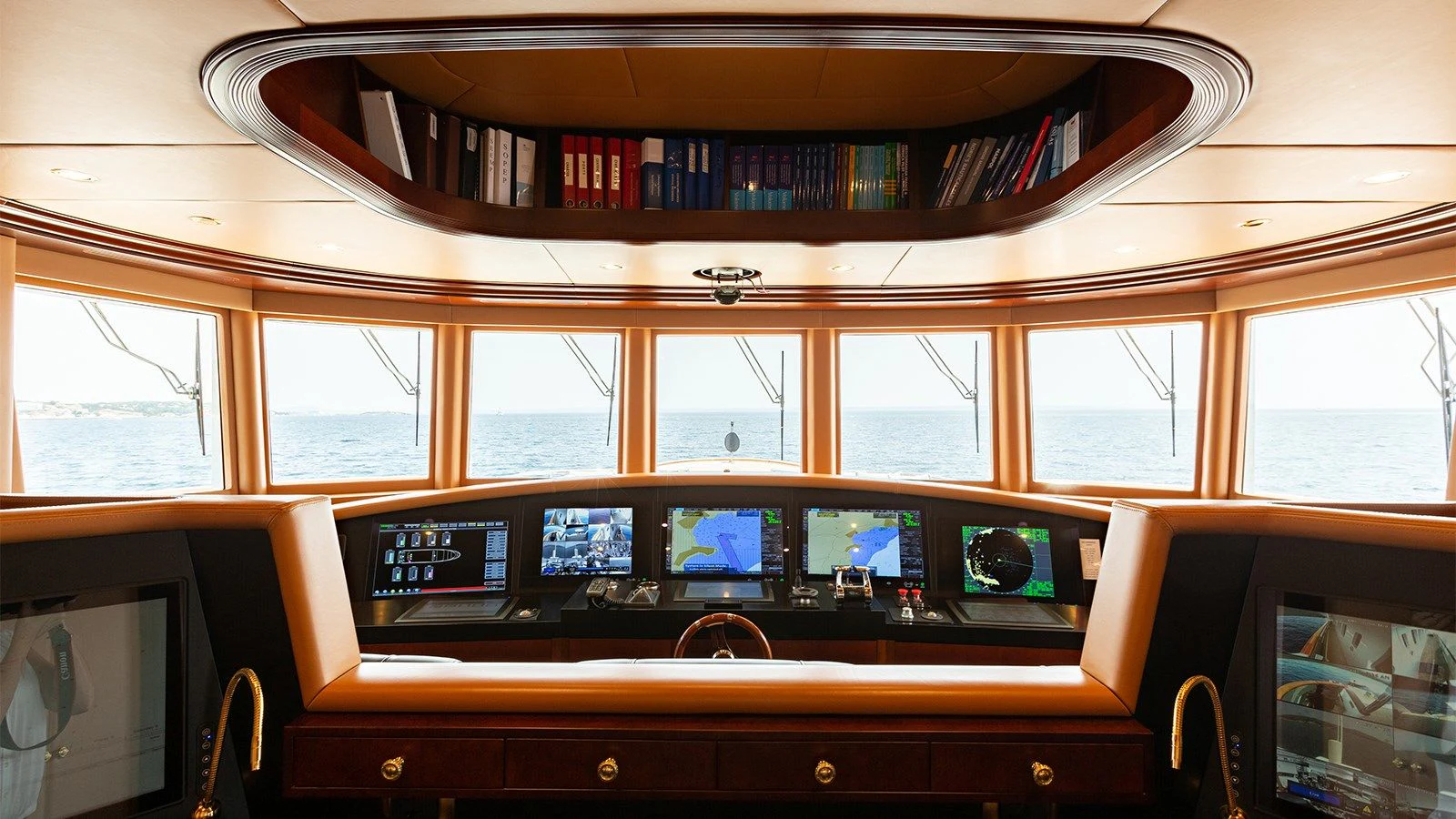 a computer desk with a book shelf aboard INCAL Yacht for Sale