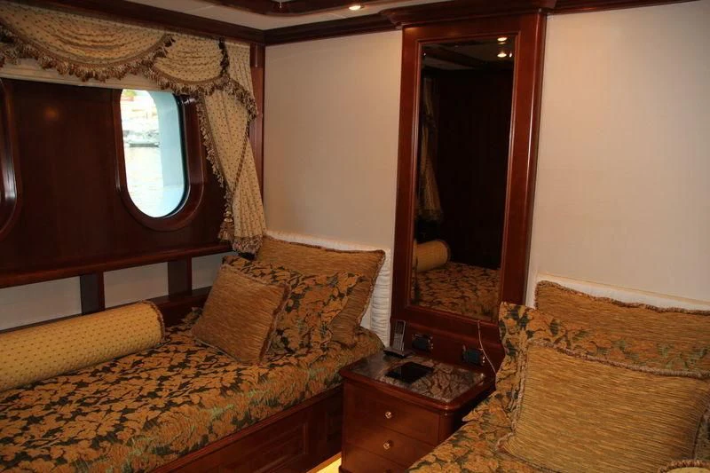 a bedroom with a bed and a mirror aboard INCAL Yacht for Sale