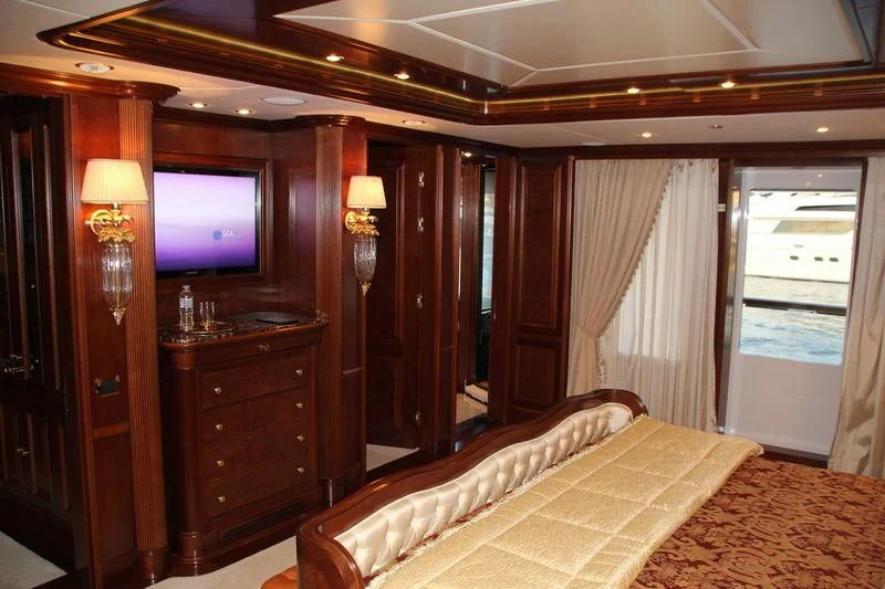 a bedroom with a tv and a bed aboard INCAL Yacht for Sale