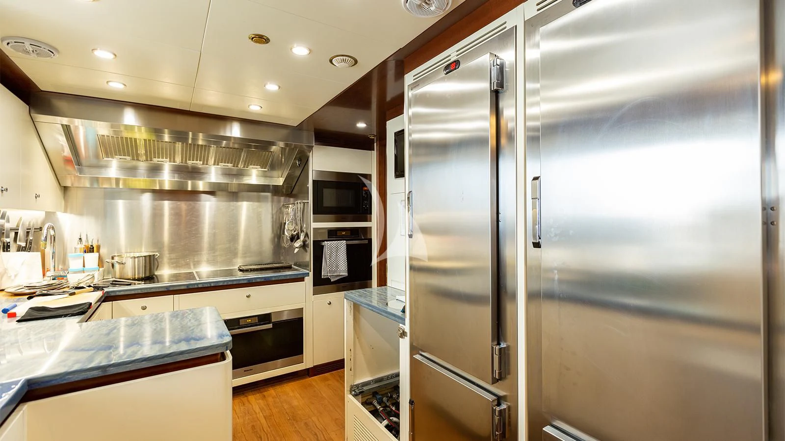 a large kitchen with stainless steel appliances aboard INCAL Yacht for Sale