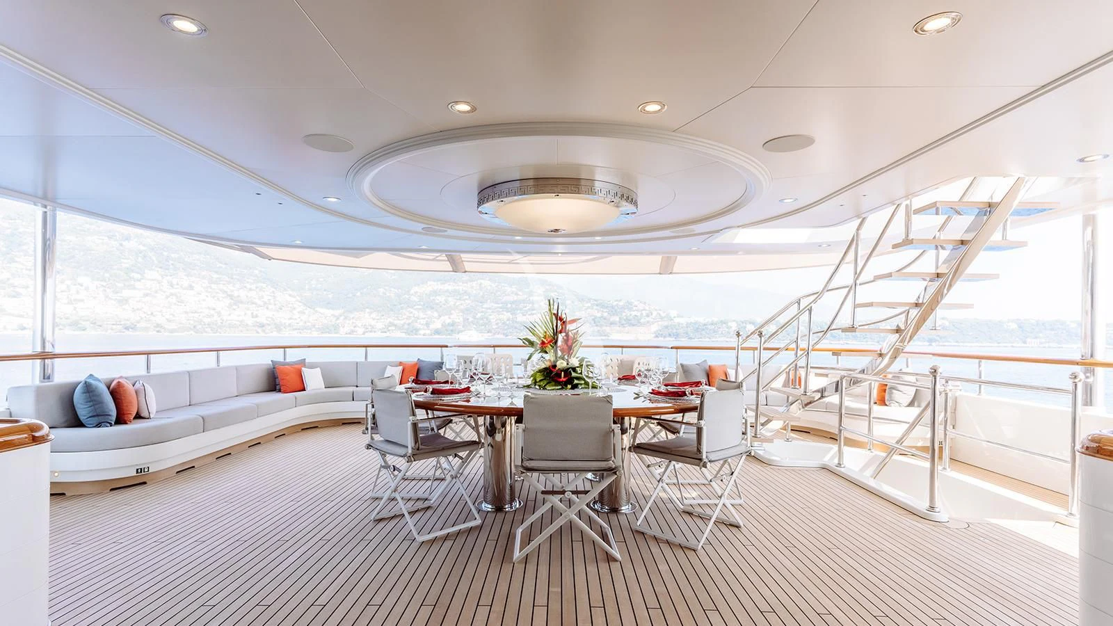 a large room with a bed and chairs and a table aboard INCAL Yacht for Sale