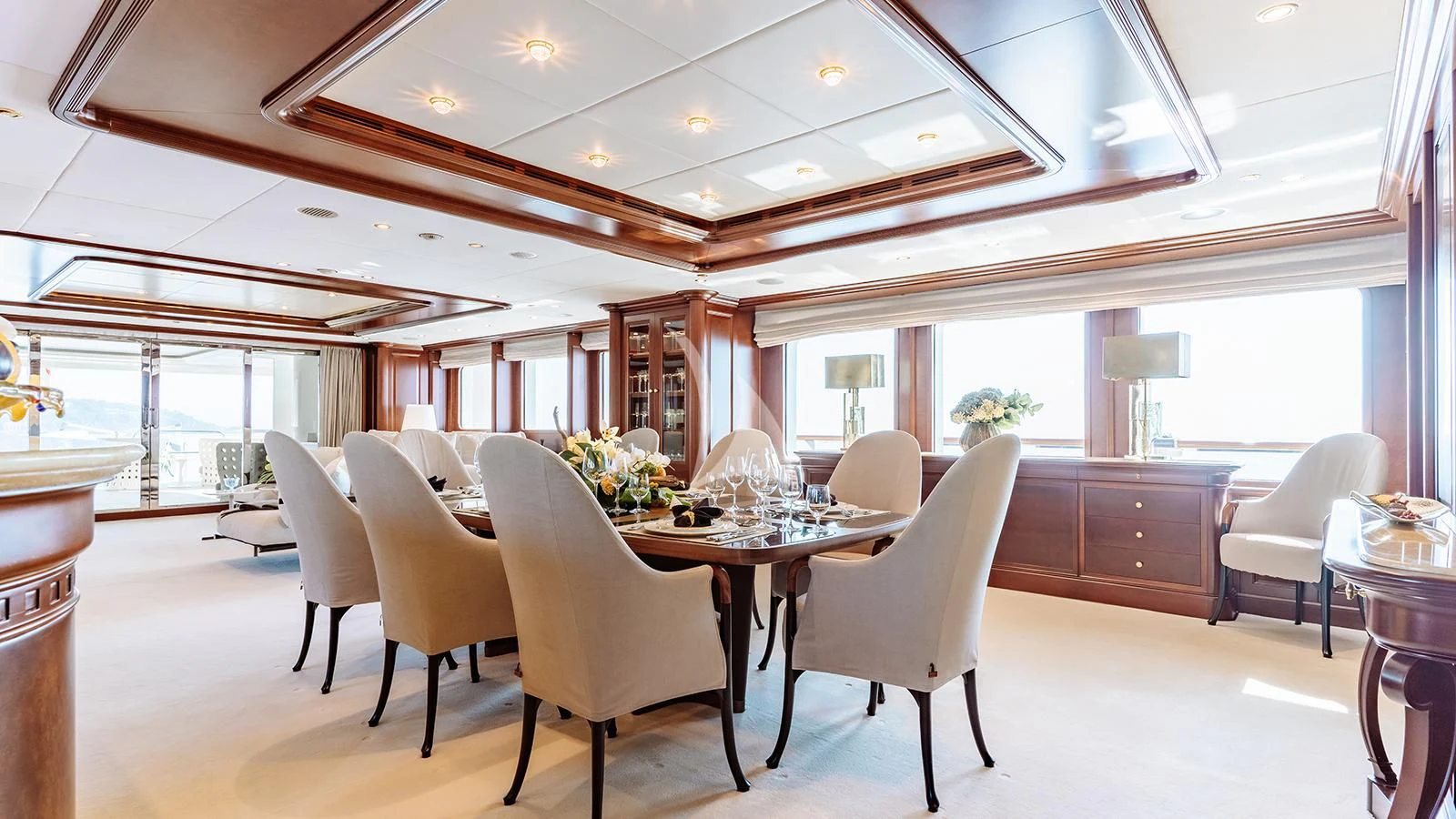 a large room with a table and chairs aboard INCAL Yacht for Sale