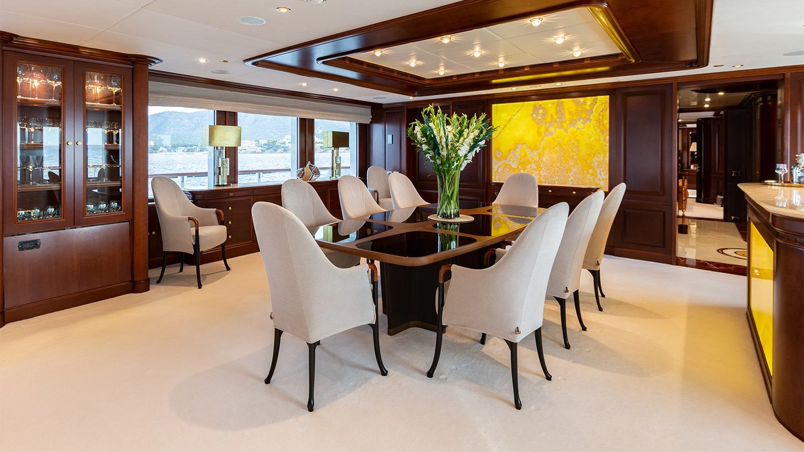 a large room with a table and chairs aboard INCAL Yacht for Sale