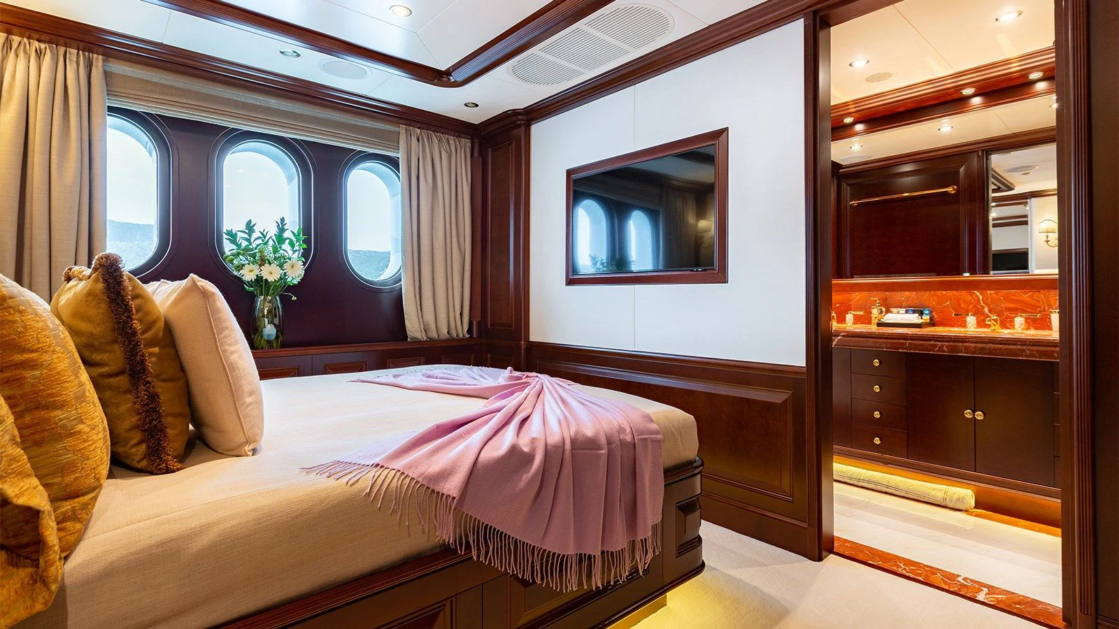 a bedroom with a bed and a mirror aboard INCAL Yacht for Sale
