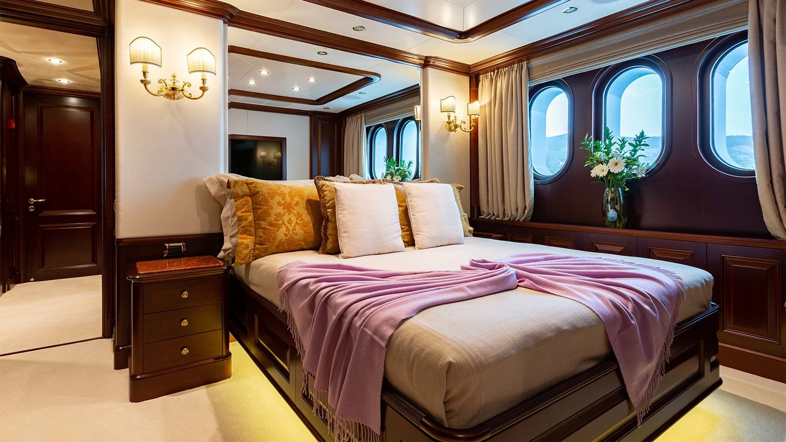 a bed with a flowered bed aboard INCAL Yacht for Sale