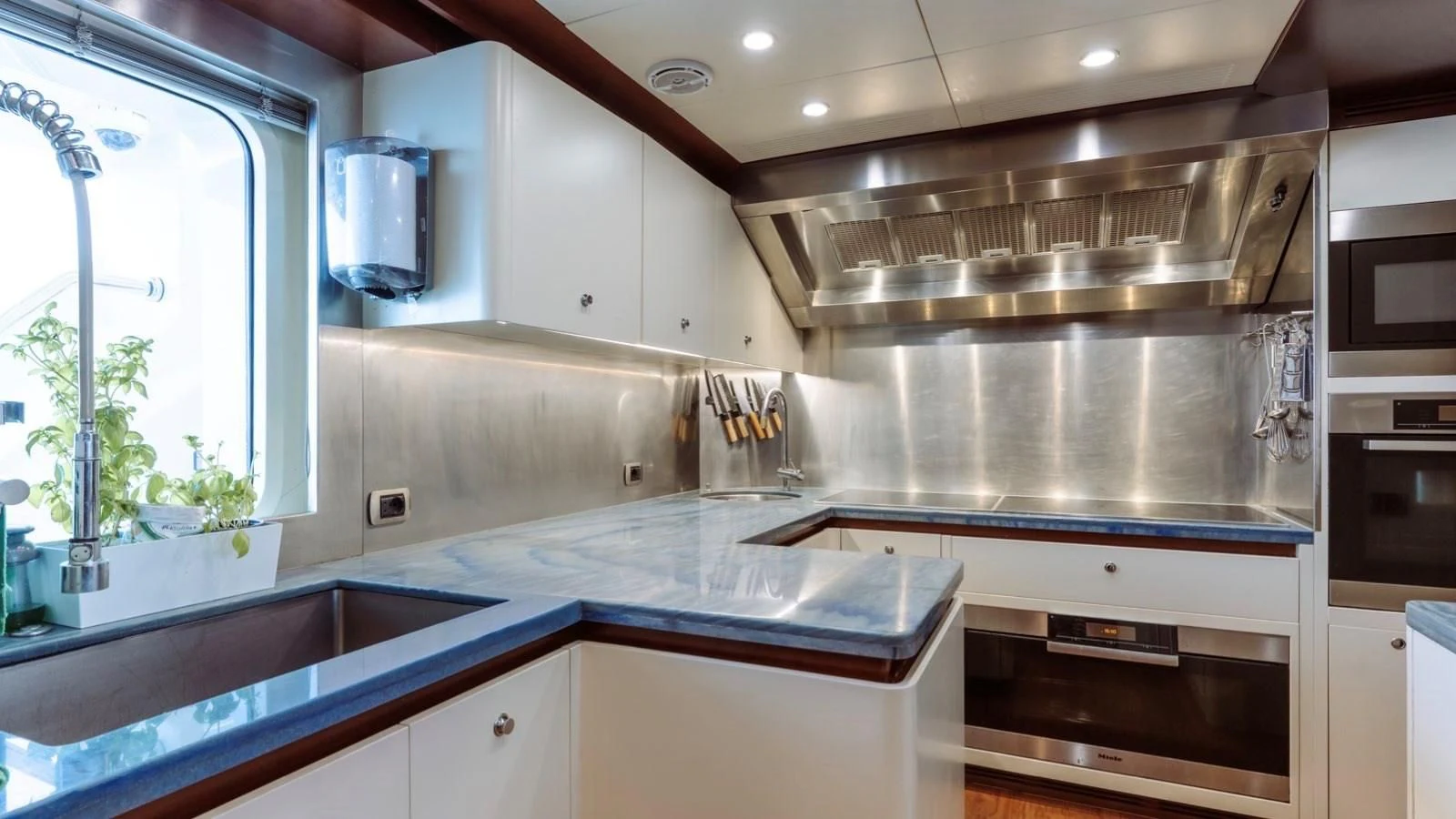 a kitchen with a stainless steel stove aboard INCAL Yacht for Sale