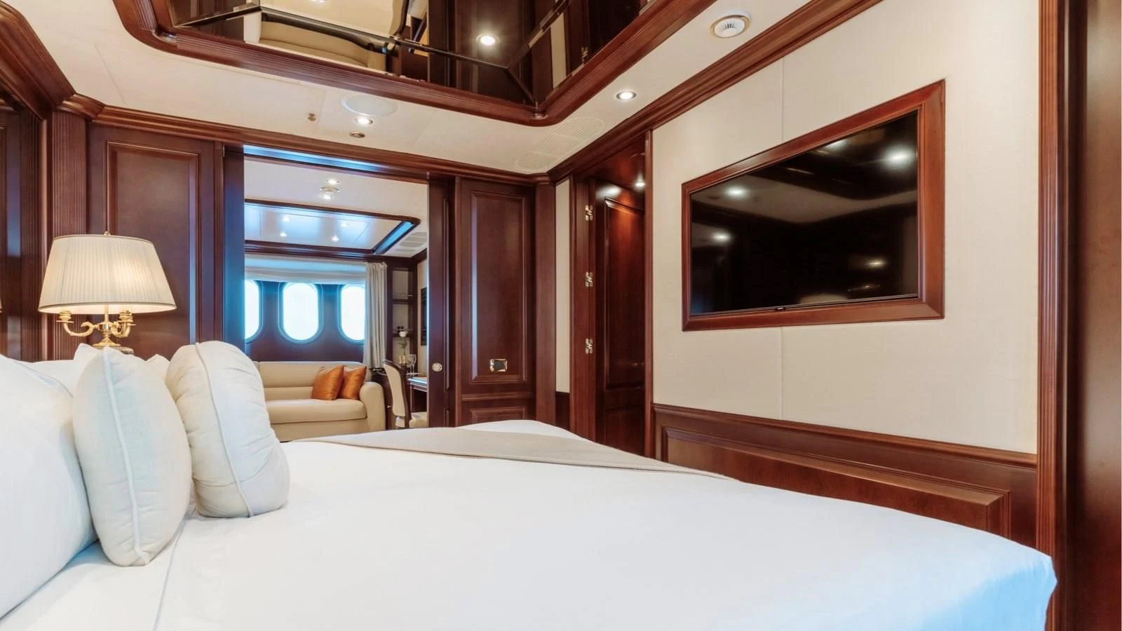 a bed with a mirror above it aboard INCAL Yacht for Sale