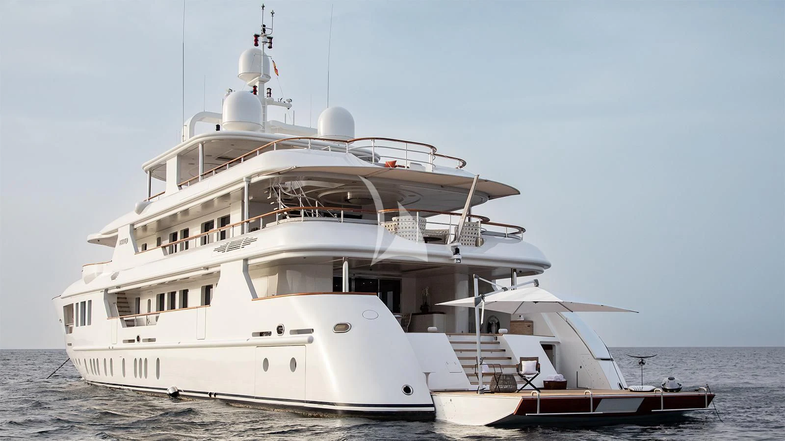 a large white boat with a smaller boat on the side aboard INCAL Yacht for Sale