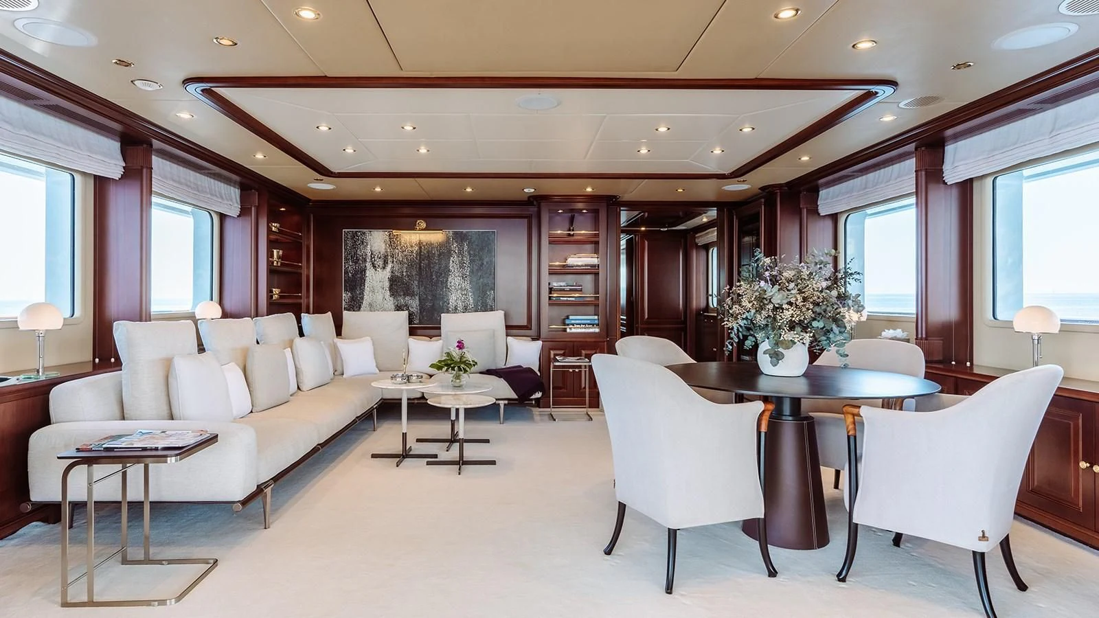 a living room with a table and chairs aboard INCAL Yacht for Sale