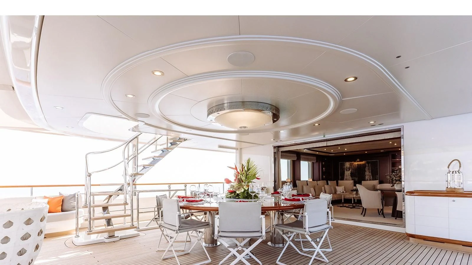 a large white room with tables and chairs aboard INCAL Yacht for Sale