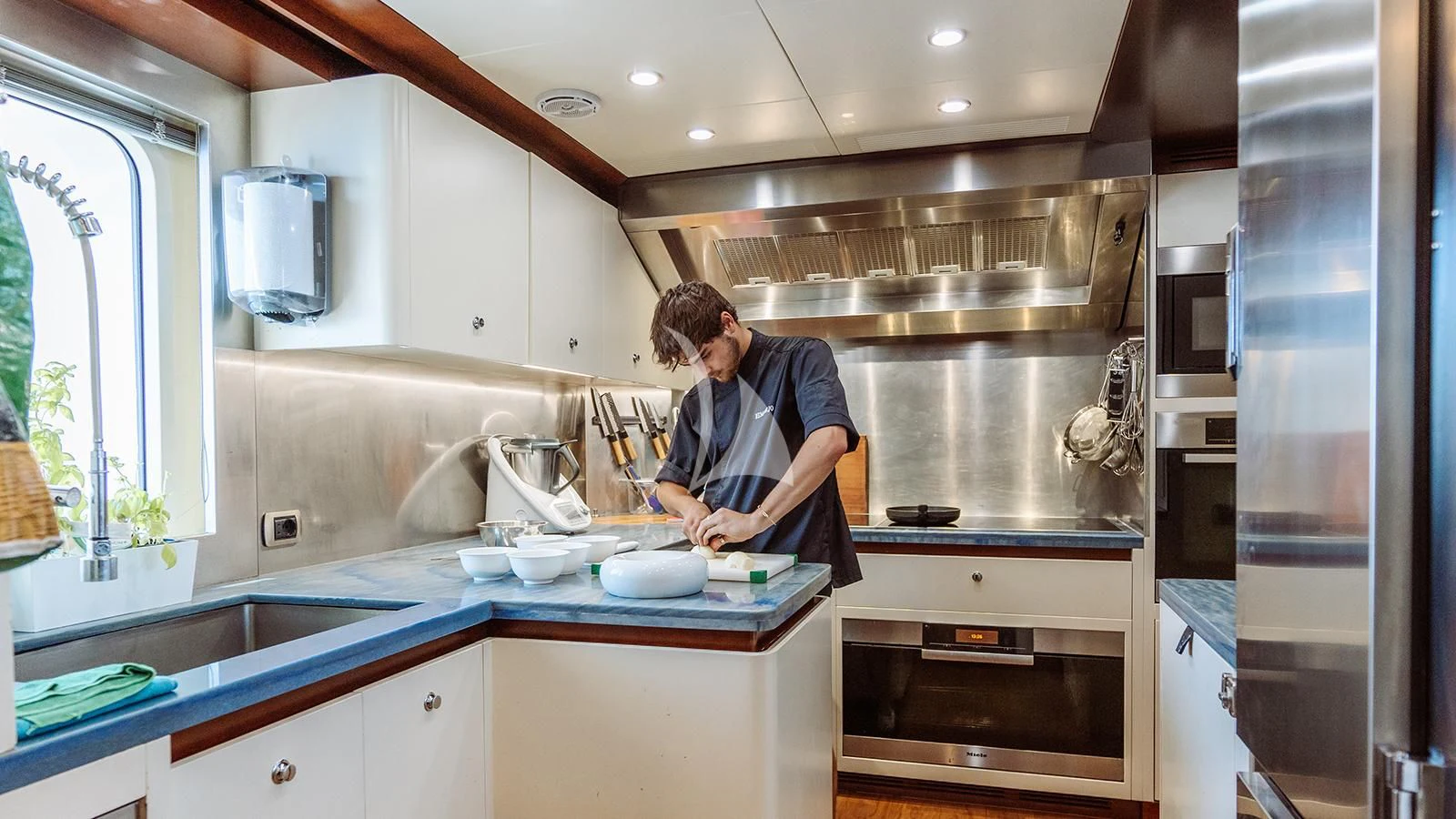a person in a kitchen aboard INCAL Yacht for Sale
