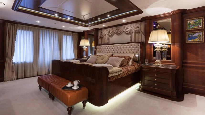 a bedroom with a bed and a table aboard INCAL Yacht for Sale
